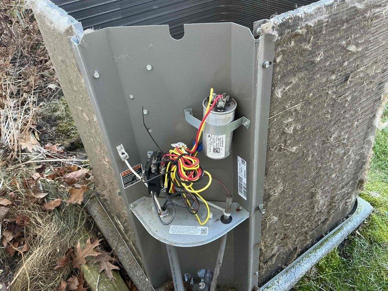 Performed routine air conditioning maintenance on Lennox HVAC system. Inspected furnace unit in utility closet and examined outdoor condenser unit, which showed significant dirt buildup and weathering. Noted capacitor connections and electrical components were intact, though exterior of condenser requires cleaning to improve system efficiency.