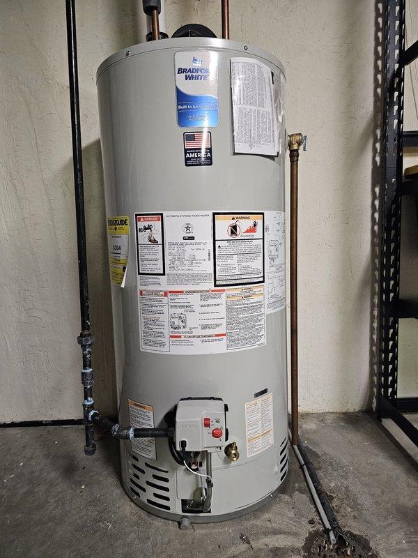 Successfully installed a 50-gallon Bradford White power vent water heater in the basement utility area. Connected copper and PVC piping with proper venting, and verified the shut-off valve location to the right of the tank in the corner. Unit was tested and confirmed to be functioning according to manufacturer specifications.