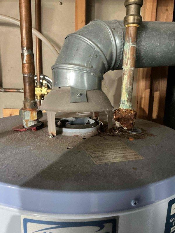 Responded to service call for furnace making loud noise. Performed diagnostic inspection on aging furnace system and identified significant corrosion at water heater connection point. Serviced furnace components to address noise issue and documented condition of HVAC system for future maintenance recommendations.