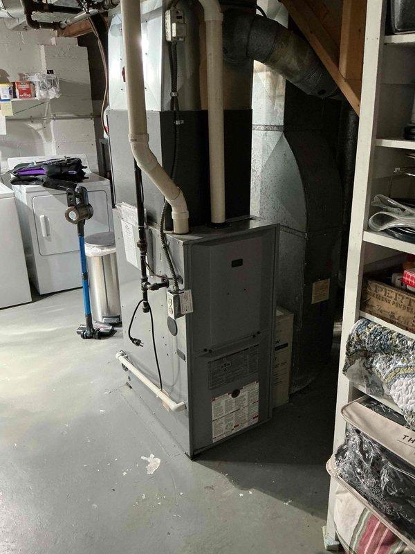 Responded to service call for furnace making loud noise. Performed diagnostic inspection on aging furnace system and identified significant corrosion at water heater connection point. Serviced furnace components to address noise issue and documented condition of HVAC system for future maintenance recommendations.