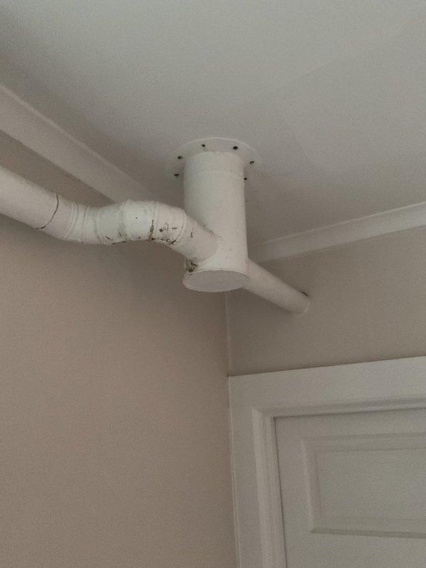 Conducted mini split assessment for replacement of outdated metal heating unit with floor-mounted installation and existing exhaust ventilation. Inspected current PVC ventilation system, noting wear on elbow joints and connection points that would require modification for new system compatibility. Recommended complete replacement of heating system with modern mini split solution to improve efficiency and eliminate ventilation issues.