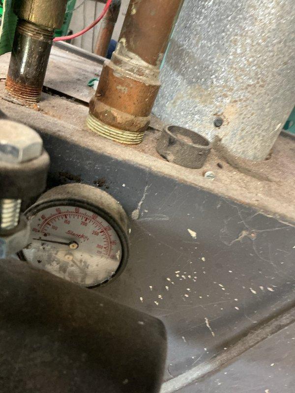 Performed service on boiler system due to intermittent pilot light failure. Inspected pressure gauge and plumbing components showing signs of oxidation. Replaced thermocouple assembly which had deteriorated, restoring proper pilot light operation and system functionality.