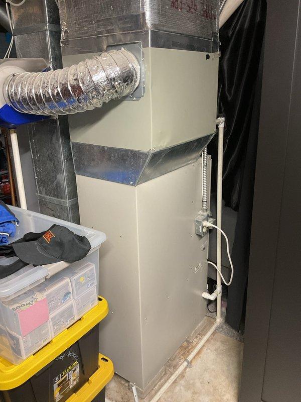 Conducted comprehensive evaluation of existing HVAC system and provided replacement estimate for both furnace and air conditioning unit. Current system includes an aging indoor air handler/furnace installed in utility area with connected flexible ductwork and drainage lines, plus an outdoor condenser unit positioned on concrete pad between house exterior and fence with electrical connections to junction box.