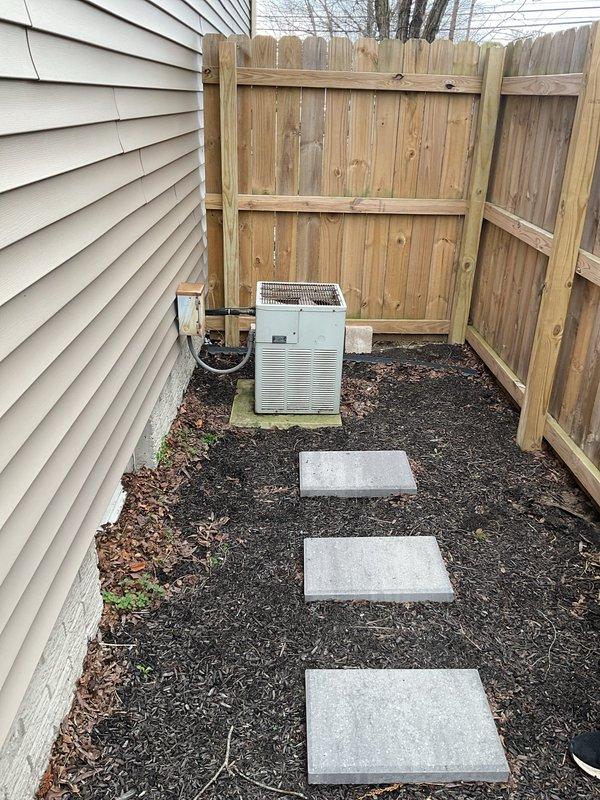 Conducted comprehensive evaluation of existing HVAC system and provided replacement estimate for both furnace and air conditioning unit. Current system includes an aging indoor air handler/furnace installed in utility area with connected flexible ductwork and drainage lines, plus an outdoor condenser unit positioned on concrete pad between house exterior and fence with electrical connections to junction box.