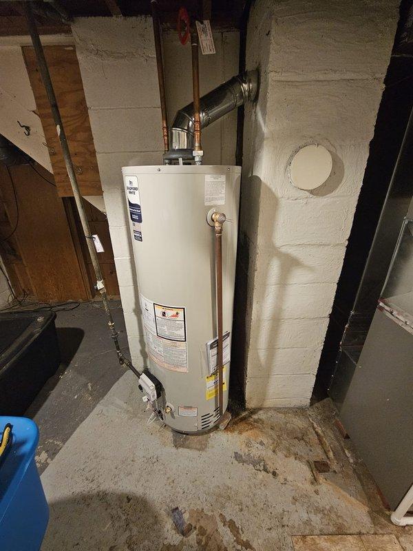 Completed installation of a new 96% efficient 70kBtu upflow furnace to replace old Lennox Pulse unit, requiring metal spacer modification for proper fitment. Installation also included a 12-gallon humidifier, 40-gallon water heater, and upgraded thermostat from T1 to Honeywell T6 Pro, with all systems properly connected to existing ductwork and properly vented with PVC piping.