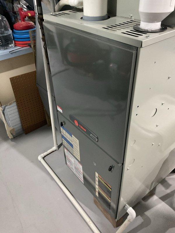 Conducted comprehensive assessment of existing Trane furnace system and provided detailed replacement estimate. Evaluated current installation including ventilation configuration with dual PVC exhaust pipes, condensate drainage system, and surrounding utility space conditions. Documented unit specifications and connections via photographic evidence to ensure accurate replacement proposal.
