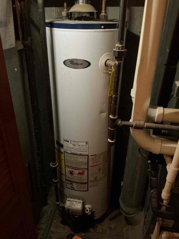 Performed scheduled maintenance on 27-year-old gas furnace. Inspected Lennox Elite HVAC system, checked connections, and verified proper operation. Adjacent Whirlpool water heater was noted but not serviced as part of this tune-up.