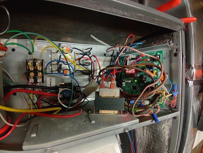 Responded to emergency no-heat call on 4-year-old system. Diagnosed faulty contactor (CONT2P4002A) showing visible corrosion at terminals. Replaced contactor, verified proper operation of control board (RJS) indicated by green LED status light, and confirmed system restoration to normal heating function.