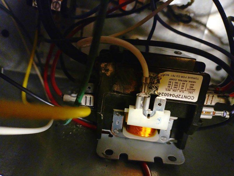 Responded to emergency no-heat call on 4-year-old system. Diagnosed faulty contactor (CONT2P4002A) showing visible corrosion at terminals. Replaced contactor, verified proper operation of control board (RJS) indicated by green LED status light, and confirmed system restoration to normal heating function.