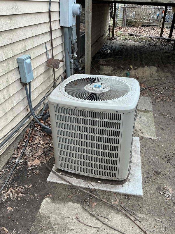 Diagnosed non-functional cooling system on combined furnace/heat pump unit showing signs of weathering and age. Identified electrical issue at the disconnect box with damaged wiring connections. Repaired compromised wiring, cleaned debris from outdoor unit, and restored proper cooling operation after verifying system functionality.
