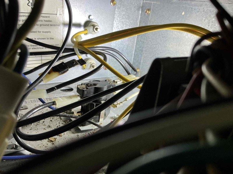Diagnosed non-functional cooling system on combined furnace/heat pump unit showing signs of weathering and age. Identified electrical issue at the disconnect box with damaged wiring connections. Repaired compromised wiring, cleaned debris from outdoor unit, and restored proper cooling operation after verifying system functionality.