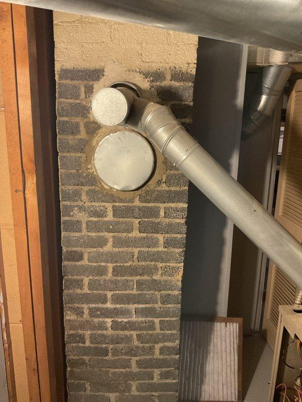 Conducted inspection of existing furnace system in basement utility area. Documented current installation which includes tan/beige furnace with PVC exhaust venting and metal ductwork connections. Provided estimate for complete furnace replacement based on observed conditions.
