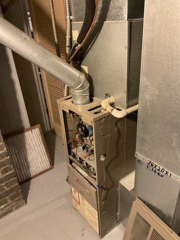 Conducted inspection of existing furnace system in basement utility area. Documented current installation which includes tan/beige furnace with PVC exhaust venting and metal ductwork connections. Provided estimate for complete furnace replacement based on observed conditions.