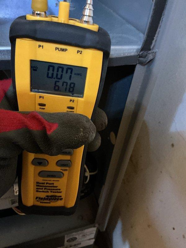 Responded to no-heat call on 10.5-year-old furnace where blower motor operation was extinguishing the pilot light. Diagnostic testing with Fieldpiece dual port manometer showed improper gas pressure readings (6.08 INWC), while multimeter testing revealed excessive voltage (583) at key components. Adjusted gas valve pressure and replaced faulty pressure switch to restore proper furnace operation and heat function.