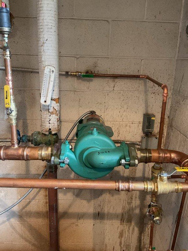 Successfully installed a new Taco circulator pump and flow valve on the heating system. Utilized pipe freezing technique to facilitate valve replacement without draining the system. All components properly connected to copper piping network and tested for proper operation.
