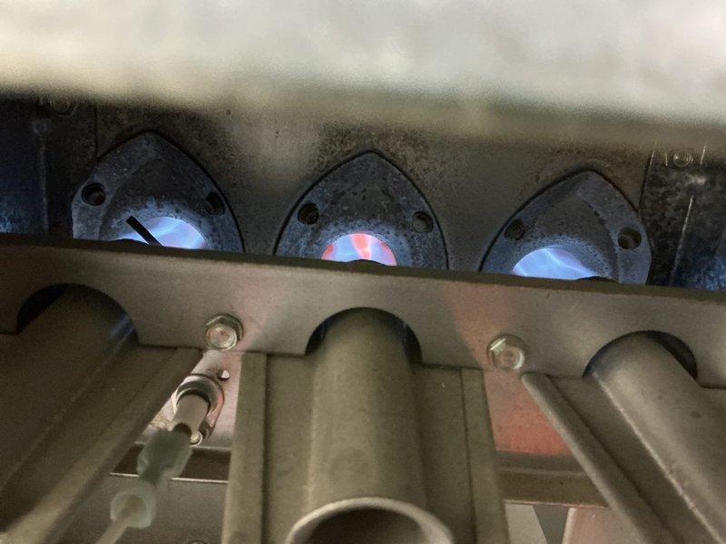 Responded to no-heat call for 10-year-old residential furnace that was shutting off immediately after ignition attempt. Diagnostic inspection revealed significant sooting and flame impingement on the heat exchanger tubes, causing the high-limit switch to trip. Performed thorough cleaning of burner assembly, removed debris from heat exchanger surfaces, and adjusted gas pressure to achieve proper flame characteristics with even blue flames across all three burners.