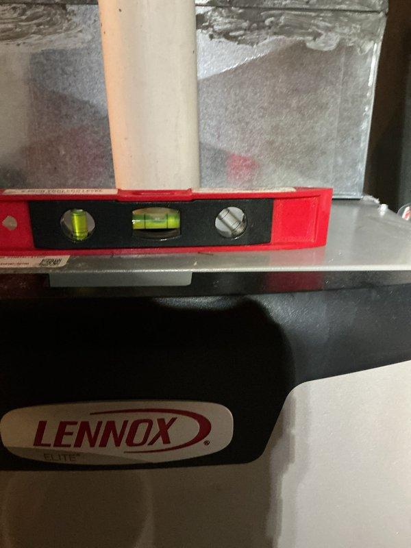 Performed scheduled furnace tune-up on Lennox unit. Verified proper equipment leveling using spirit level and inspected air filter, which showed normal particulate accumulation. System operating within specifications after service.