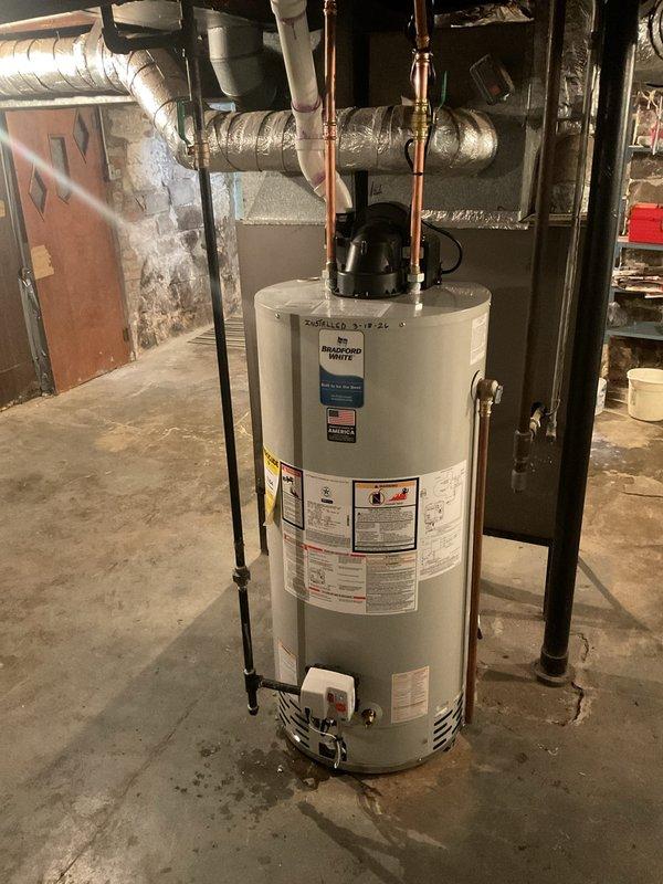 Successfully installed a 50-gallon water heater in the basement utility area, connecting copper hot/cold water lines and ensuring proper integration with existing plumbing system. All connections were secured and tested for leaks, with PVC pipes properly marked according to code requirements. The installation area was left clean and organized with all components functioning as designed.