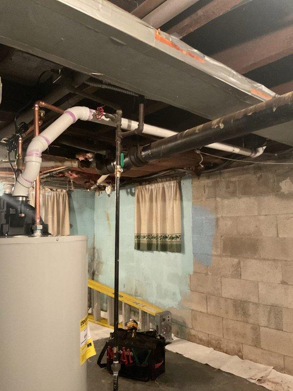 Successfully installed a 50-gallon water heater in the basement utility area, connecting copper hot/cold water lines and ensuring proper integration with existing plumbing system. All connections were secured and tested for leaks, with PVC pipes properly marked according to code requirements. The installation area was left clean and organized with all components functioning as designed.