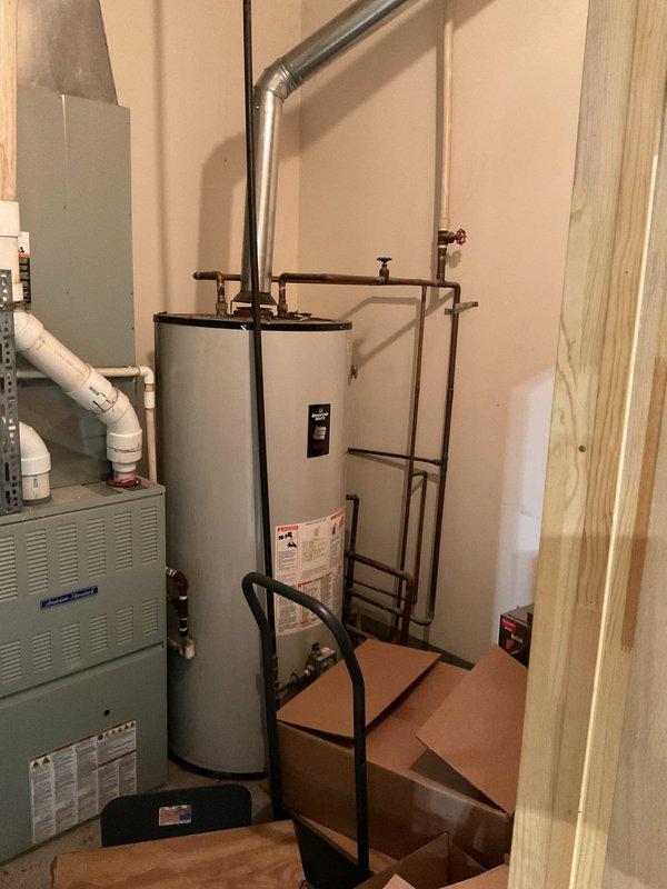 Conducted site assessment for washer and dryer hook-up installation in residential utility area. Evaluated existing plumbing configuration near water heater and HVAC system, documenting current pipe layout and available connection points. Materials for installation have been staged on-site pending final installation.