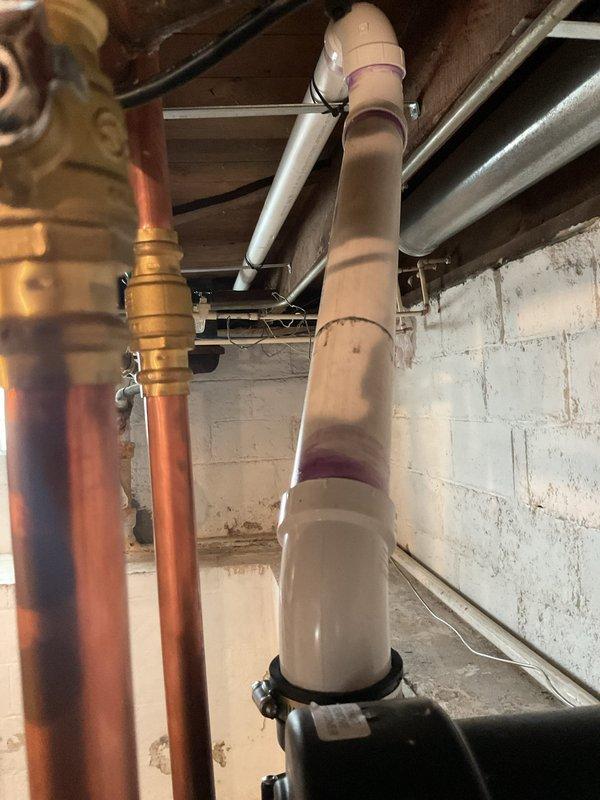 Successfully installed a new 40-gallon power vent water heater in basement utility area, properly connecting all copper supply lines and PVC venting. Capped off existing flue pipe as requested and verified all connections for proper operation.