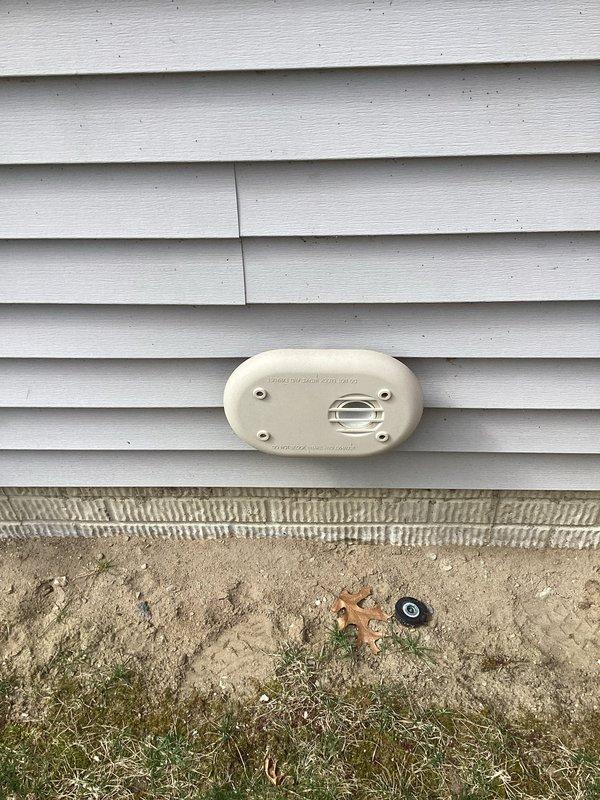 Responded to installation inspection violation regarding improper venting material. Upon arrival, located HVAC exhaust termination on exterior wall with cellcore piping used for combustion venting system. Inspected interior mechanical chase and confirmed non-compliant cellcore pipe installation running vertically through shaft. Documented existing conditions with photographs showing exterior termination point with beige oval vent cover mounted on vinyl siding and interior view of gray metal ducts within the vertical chase space. Corrected venting system by replacing cellcore piping with proper CPVC or approved venting material per manufacturer specifications and local code requirements to ensure safe exhaust of combustion gases and pass final inspection.