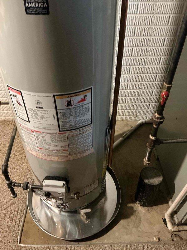 Responded to service call for 27-year-old gas water heater experiencing flame roll-out condition. Upon inspection, discovered severely corroded burner assembly and heat exchanger components with extensive rust deterioration and white crystalline deposits indicative of combustion byproduct accumulation. The flame roll-out condition posed immediate safety hazard due to compromised combustion chamber integrity and improper venting of exhaust gases. Documented extensive corrosion throughout burner components and recommended immediate replacement of unit due to age, advanced deterioration, and safety concerns that cannot be adequately addressed through repair.
