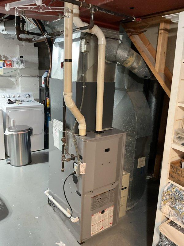 Completed comprehensive assessment of existing HVAC system for furnace replacement in residential basement utility area. Evaluated current beige furnace unit, associated ductwork including galvanized metal plenum and flexible insulated ducts, and all connected components including copper and black pipe gas lines with shutoff valves. Documented equipment specifications, installation configuration, and existing PVC venting system to provide accurate replacement estimate with appropriate sizing and compatibility requirements for new furnace installation.