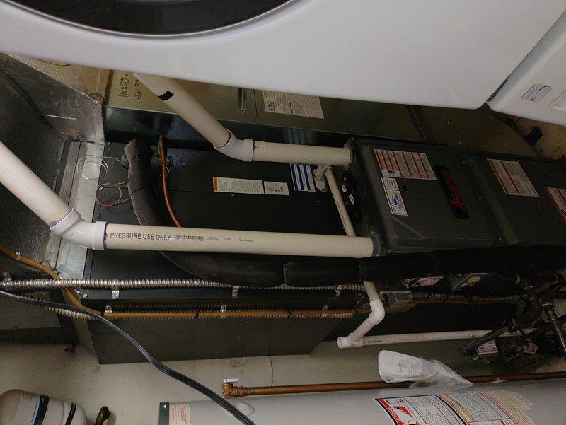 Responded to no-heat call for 10-year-old furnace unable to maintain temperature above 61-64 degrees. Inspected HVAC system including furnace unit, condensate pump assembly, and associated drainage components. Verified proper installation of condensate removal system with PVC piping connections and confirmed operational status of mechanical equipment in utility space.