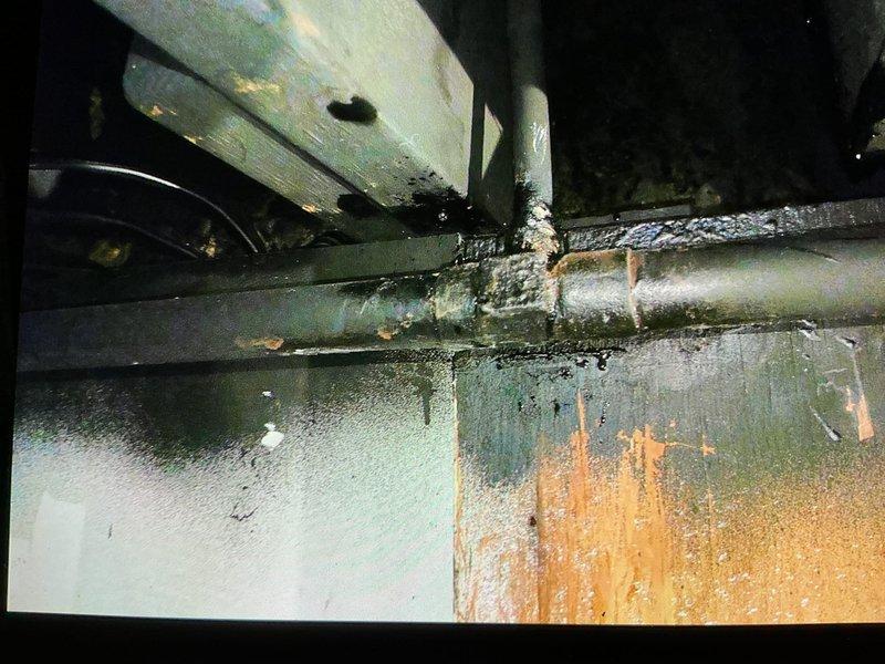 Responded to boiler pipe failure with immediate system shutdown and drain-down to prevent further water damage. Assessed broken piping configuration, identifying ceiling-mounted pipe as 1.25 to 1.5 inch diameter and vertical riser as approximately 5/8 inch diameter, though measurements complicated by multiple paint layers. Documented extensive corrosion, rust staining, and moisture damage throughout system components via photo documentation. Provided temporary heating solution with two electric space heaters to maintain building comfort during repair period. Scheduled follow-up appointment to complete pipe repair using pro-press connection method.
