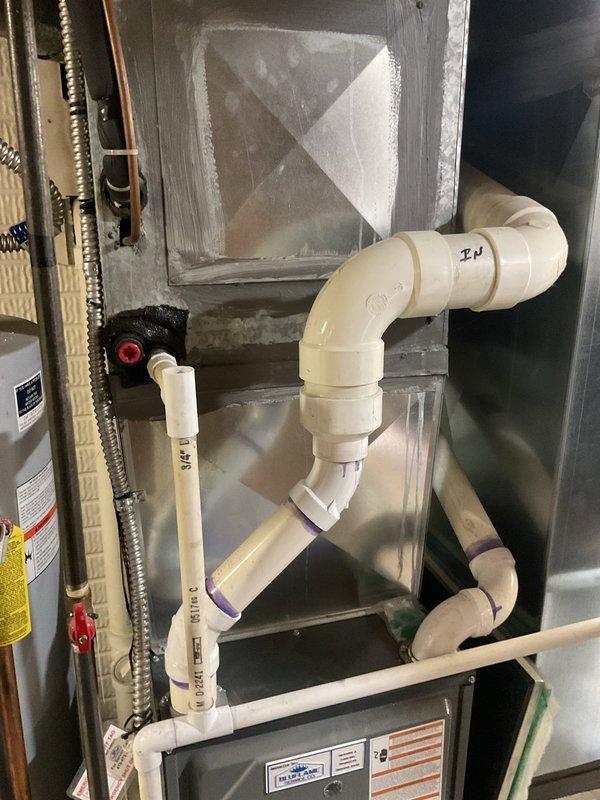 Completed comprehensive evaluation of existing HVAC system for replacement estimate. Assessed outdoor condensing unit positioned on concrete pad against building exterior and documented current condition. Inspected indoor air handler and associated condensate drainage system within mechanical closet, noting existing PVC piping configuration and water heater proximity. Provided detailed photographic documentation of both exterior and interior components to support replacement system specifications and installation planning.