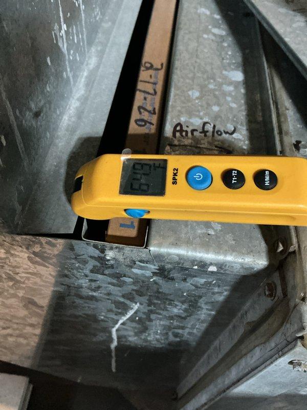 Completed warranty AC system startup and commissioning. Verified proper condensate drain line installation with PVC piping and flexible coupling connections, confirming secure mounting and leak-free operation. Performed airflow measurements at supply ductwork, recording 55.4 CFM readings to validate system performance meets manufacturer specifications. System operational and functioning within normal parameters.