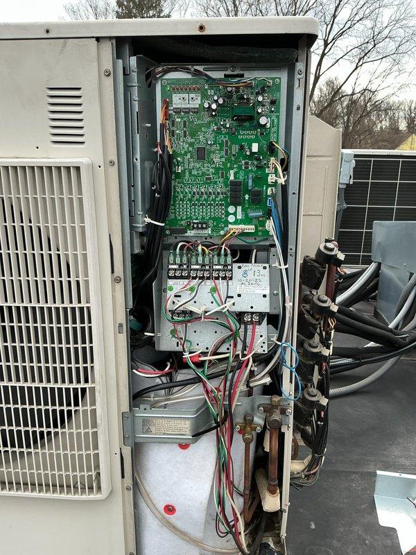 Responded to service call for 10-year-old mini split system not blowing or operating properly. Upon arrival, accessed outdoor condensing unit on rooftop and performed diagnostic inspection of internal components including control board, electrical connections, compressor, and refrigerant lines. Inspected green circuit board for signs of failure, verified wiring connections at terminal blocks, and examined copper refrigerant tubing and associated connections. Unit was evaluated for proper operation and necessary repairs identified to restore system functionality.