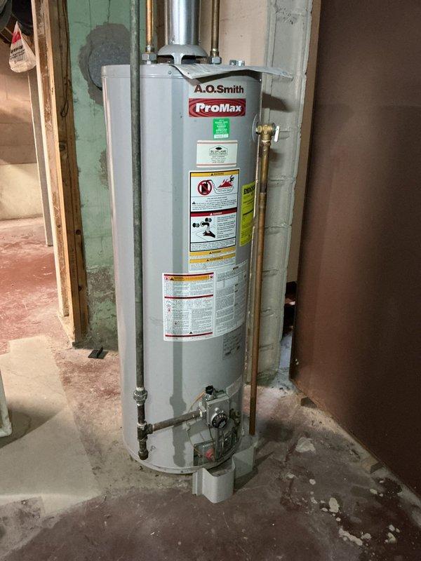 Responded to emergency call for non-operational furnace and water heater at commercial facility. Upon arrival, conducted thorough inspection of both systems with no error codes or indicator lights present on either unit. Assessed A.O. Smith ProMax water heater installation, examining gas control valve assembly, flue pipe connections, and water supply lines. Inspected attic space HVAC components including ductwork, piping infrastructure, and ventilation systems for potential issues affecting system operation. Documented equipment conditions and configurations through photographic records for service history. Systems evaluated for proper gas supply, electrical connections, and safety controls to identify root cause of simultaneous equipment failure.