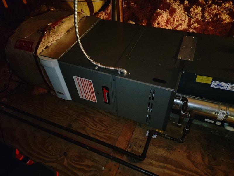 Performed comprehensive clean and check maintenance on 9-year-old residential heating and cooling system, including furnace and air conditioning components located in attic installation. Serviced Amana condensing unit on exterior pad, inspected air handler with ductwork connections, and installed media filter (#210/#410). All equipment operating within normal parameters upon completion of tune-up procedures.