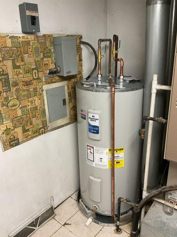 Installed a new Bradford White 50-gallon short electric water heater in the utility room. Connected copper supply lines and electrical service to the unit, ensuring proper voltage configuration for the 240V/208V dual-element system with 4500-watt heating elements. Verified all connections, tested unit operation, and confirmed compliance with manufacturer specifications and safety standards.