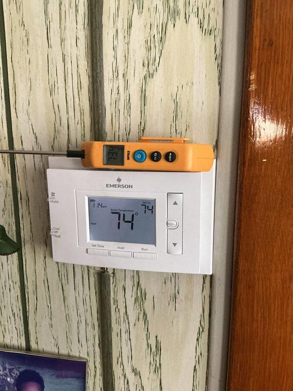 Responded to service call for thermostat that would not shut off when turned to off position. Upon arrival, found Emerson digital thermostat controlling both heating and cooling systems and continuously calling for operation regardless of switch position. Performed diagnostic testing using multimeter to check for voltage irregularities and wiring issues at thermostat terminals. Identified faulty internal relay preventing proper system shutdown. Replaced malfunctioning thermostat with new Honeywell Home digital programmable unit. Verified proper wiring connections at R, W, Y, and G terminals. Tested all system functions including heating mode, cooling mode, and fan operation. Confirmed thermostat now properly cycles system on and off as commanded and maintains accurate temperature control at 73-74 degrees. System operating correctly at time of departure.