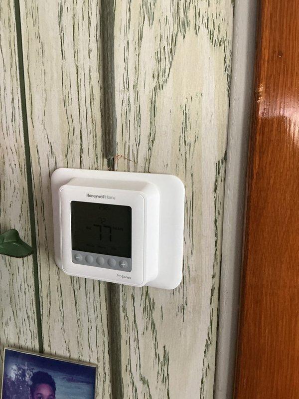 Responded to service call for thermostat that would not shut off when turned to off position. Upon arrival, found Emerson digital thermostat controlling both heating and cooling systems and continuously calling for operation regardless of switch position. Performed diagnostic testing using multimeter to check for voltage irregularities and wiring issues at thermostat terminals. Identified faulty internal relay preventing proper system shutdown. Replaced malfunctioning thermostat with new Honeywell Home digital programmable unit. Verified proper wiring connections at R, W, Y, and G terminals. Tested all system functions including heating mode, cooling mode, and fan operation. Confirmed thermostat now properly cycles system on and off as commanded and maintains accurate temperature control at 73-74 degrees. System operating correctly at time of departure.