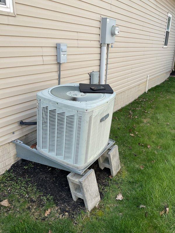 Conducted on-site assessment for air conditioning replacement estimate at residential property with existing furnace previously installed by our company. Inspected current outdoor condensing unit mounted on concrete blocks with proper electrical disconnect and conduit installation, along with indoor air handler connected to water heater via PVC venting system. Documented equipment specifications, installation configurations, and system compatibility to prepare comprehensive replacement proposal for new AC system that will integrate with existing furnace infrastructure.