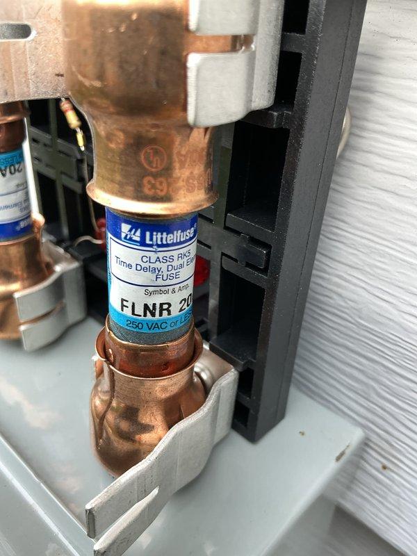 Completed startup and commissioning of new natural gas air conditioning system. Verified proper electrical protection with 25-amp time-delay fuses installed and secured in disconnect, and confirmed supply air temperature of 49.3°F at the ductwork, indicating system is cooling effectively and operating within normal parameters.