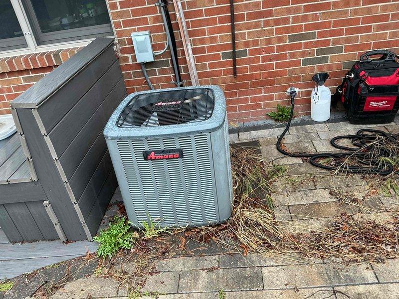 Performed comprehensive spring maintenance on Amana air conditioning system. Inspected and tested electrical disconnect box, verifying all wire connections and terminal integrity. Cleaned condenser coil, checked refrigerant lines and insulation, tested system operation and confirmed proper cooling performance. Unit operating within normal parameters with no issues identified.