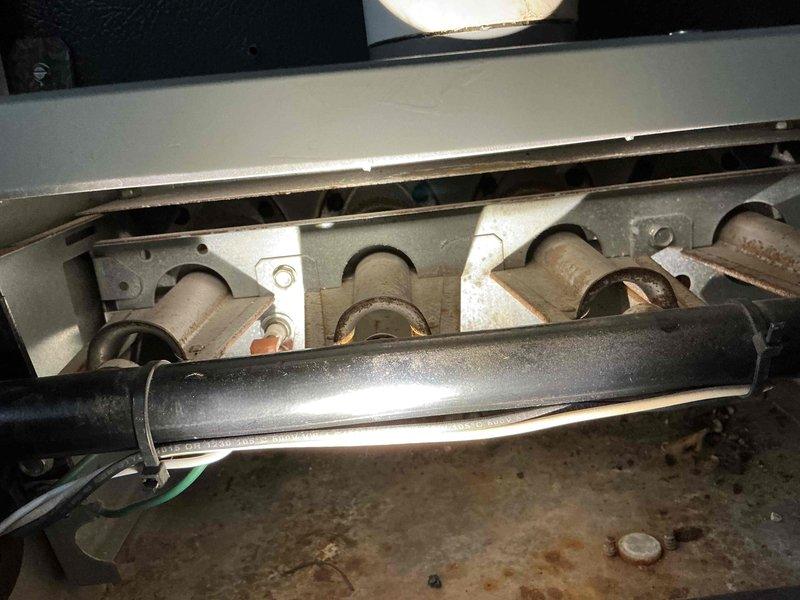 # No Heat Service Call - 10-Year-Old Furnace

Responded to service call for furnace blowing cold air on a 10-year-old gas-fired heating unit. Upon arrival, contacted customer via phone while en route to confirm appointment window. Performed comprehensive diagnostic inspection of furnace system including visual examination of heat exchanger, burner assembly, and all internal components.

## Diagnostic Findings

Conducted thorough assessment of furnace operation and internal components. Inspected burner tubes showing normal age-related surface oxidation and dust accumulation consistent with 10 years of operation. Examined heat exchanger assembly for signs of deterioration, cracks, or failure points. Verified proper venting configuration with PVC intake and exhaust pipes. Checked electrical connections, control board functionality, and safety switch operations.

## Work Performed

- Tested thermostat call for heat and verified signal to furnace control board
- Inspected ignition system in