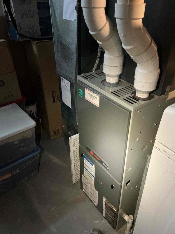 # No Heat Service Call - 10-Year-Old Furnace

Responded to service call for furnace blowing cold air on a 10-year-old gas-fired heating unit. Upon arrival, contacted customer via phone while en route to confirm appointment window. Performed comprehensive diagnostic inspection of furnace system including visual examination of heat exchanger, burner assembly, and all internal components.

## Diagnostic Findings

Conducted thorough assessment of furnace operation and internal components. Inspected burner tubes showing normal age-related surface oxidation and dust accumulation consistent with 10 years of operation. Examined heat exchanger assembly for signs of deterioration, cracks, or failure points. Verified proper venting configuration with PVC intake and exhaust pipes. Checked electrical connections, control board functionality, and safety switch operations.

## Work Performed

- Tested thermostat call for heat and verified signal to furnace control board
- Inspected ignition system in