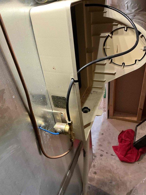 Responded to water leak concern near HVAC system. Upon arrival, inspected area where standing water was reported around equipment. Discovered heavily soiled air filter with significant debris accumulation that was restricting airflow and causing condensate drainage issues. Identified water heater in proximity to HVAC system with copper piping and shutoff valve. Documented conditions with photographs showing filter condition and equipment setup. Removed and displayed contaminated filter to show extent of blockage. Recommended filter replacement and verified condensate drain line functionality to prevent future water accumulation issues.