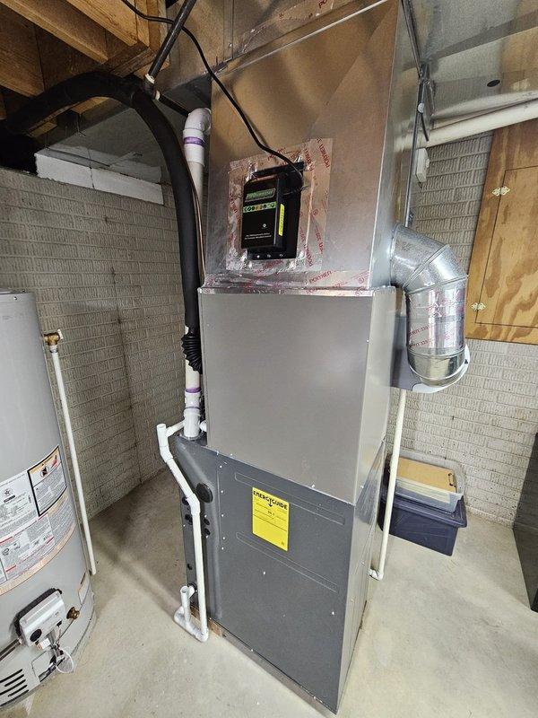 Completed installation of 14 SEER 2.5 ton single-stage air conditioning system with matching upflow cased coil to replace existing ductboard setup. Installed new 3/4" x 35' line set, positioned condenser unit on new concrete pad placed 3 feet from electrical meter per specifications, and connected electrical disconnect with whip. Programmed and mounted Honeywell T6 Pro thermostat to complete system setup and verified proper operation of all components.