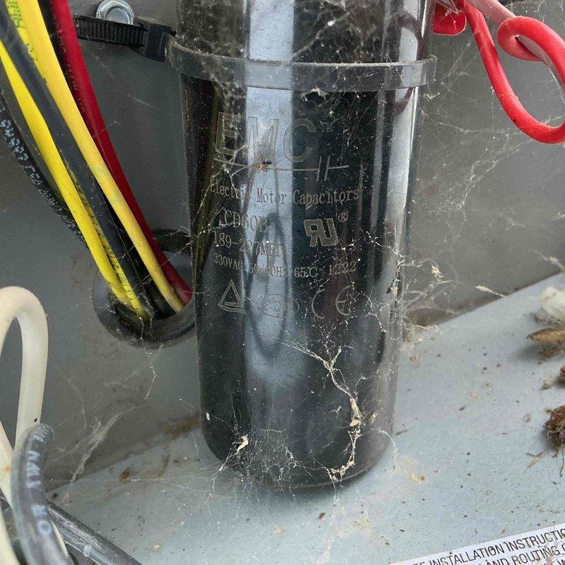 Responded to service call for 2-year-old furnace displaying red fault light and producing intermittent banging noise approximately once per hour. Upon arrival, inspected system components and identified failed motor capacitor with visible deterioration and debris accumulation. Replaced defective capacitor, cleaned electrical connections, tested system operation, and verified proper furnace startup sequence with no abnormal sounds or fault indicators.