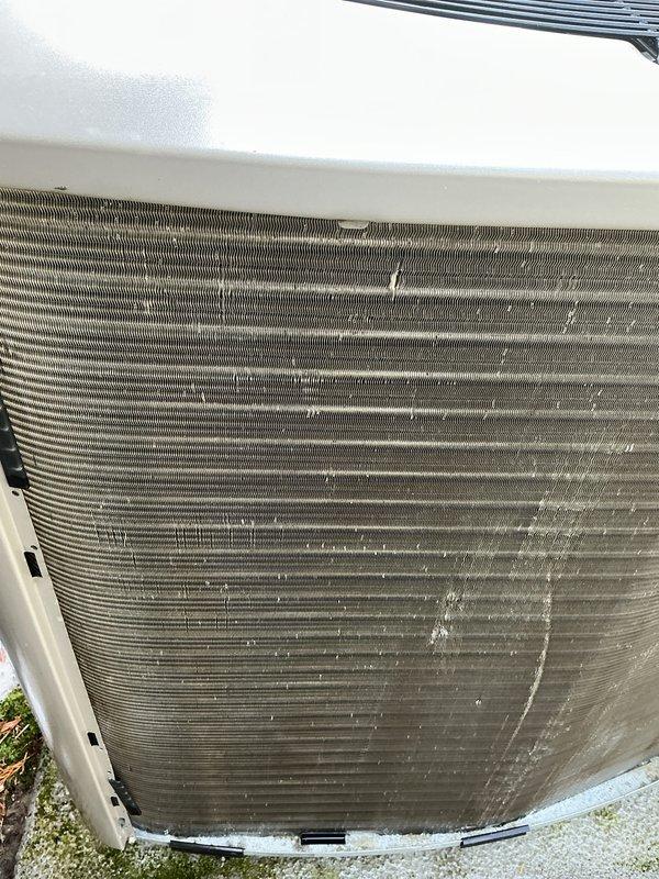 Performed visual inspection of outdoor AC unit and associated electrical disconnect box. Unit exterior and condenser coils showed moderate accumulation of dirt, dust, and debris. Documented current condition of equipment and surrounding area with photographs per service protocol.