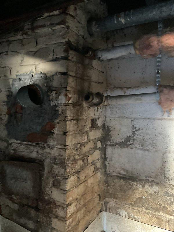 Conducted comprehensive water heater replacement estimate in basement utility area. Documented existing conditions including aged infrastructure, deteriorated masonry walls with water staining, exposed ductwork, and current mechanical system layout. Assessed installation requirements, clearance specifications, venting pathways, and necessary modifications to accommodate new water heater unit while ensuring compliance with current plumbing codes and manufacturer specifications.