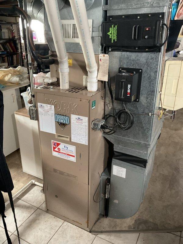 Conducted comprehensive assessment of existing residential HVAC system for complete furnace and air conditioning replacement. Evaluated current equipment configuration in basement utility area, including furnace unit, air handler, ductwork connections, and electrical service panel. Documented existing installation with PVC venting system, electrical connections including Honeywell controls and digital thermostats, and breaker panel specifications to develop accurate replacement proposal. Provided detailed estimate for new HVAC system installation including equipment removal, new furnace and AC unit installation, electrical upgrades as needed, and proper venting configuration to meet current code requirements.
