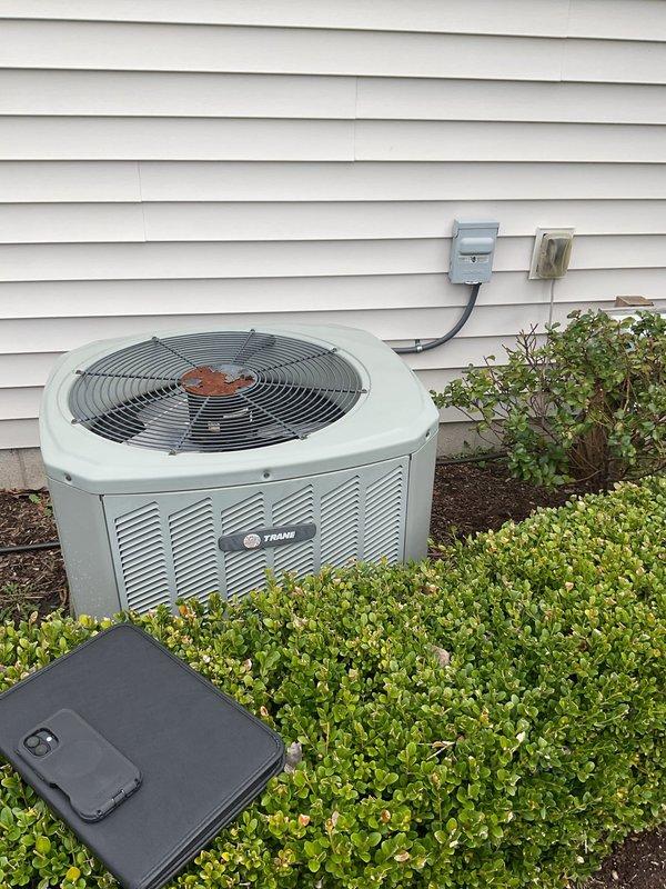 Conducted comprehensive HVAC system evaluation for complete equipment replacement. Assessed existing indoor furnace unit located in utility closet alongside water heater, noting current ductwork configuration with flexible connections and PVC condensate drainage system. Evaluated outdoor Trane air conditioning unit positioned on exterior of residence with existing electrical disconnect and refrigerant line set routing along siding. Documented equipment specifications, clearances, and installation parameters. Photographed current system layout including indoor air handler placement, utility closet dimensions, ductwork connections, and outdoor condenser location within landscaped area. Reviewed electrical service requirements and existing condensate drain routing. Prepared detailed replacement estimate for new high-efficiency HVAC system including equipment specifications, installation requirements, and necessary modifications to existing infrastructure.